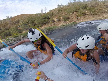 in the rapids on a Sierra Nevada College student activities whitewater rafting and camping trip on the South Fork of the American River