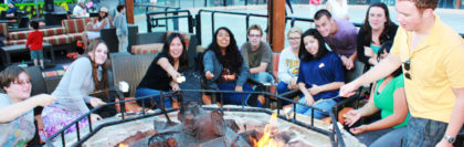 New to SNU Tahoe, students mingle around a fire at Northstar for their New Student Orientation