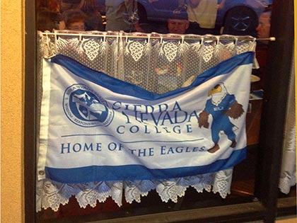 SNC banner in a restaurant window during the SNC Tahoe 2013 homecoming celebration
