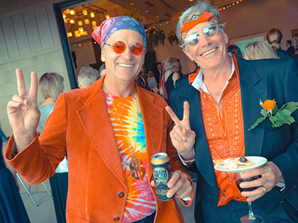 Guests in tie-dye and Indian print black tie at the SNC 2019 Summer of Love gala.