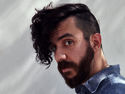Portrait of poet Kaveh Akbar author of Calling a Wolf a Wolf and Pilgrim Bell