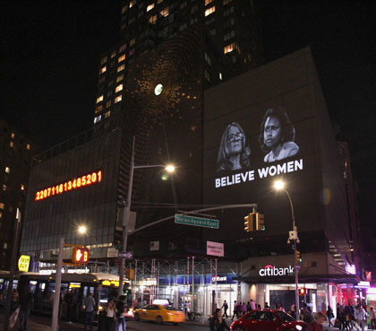 Believe Women projection-intervention project showing images of Anita Hill and Christine Blasey Ford on a skyscraper by the Illuminator artist collective