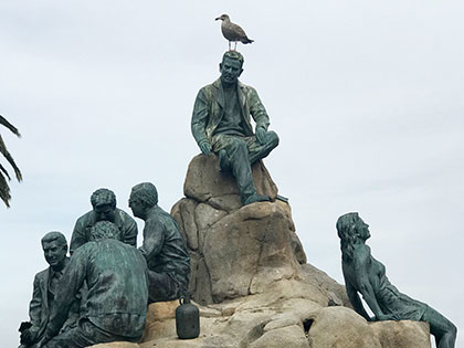 The John Steinbeck monument on Cannery Row in Monterey. Steinbeck is top, with seagull.