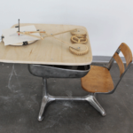 Sculpture of wooden mechanism on old fashioned school desk by SNC BFA graduate Collyn Aubrey, winner of the 2017 Perspectives on Design award