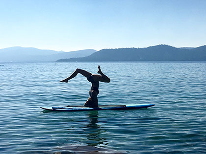 Journalism student Kyly Clark does a headstand on her paddleboard on Lake Tahoe