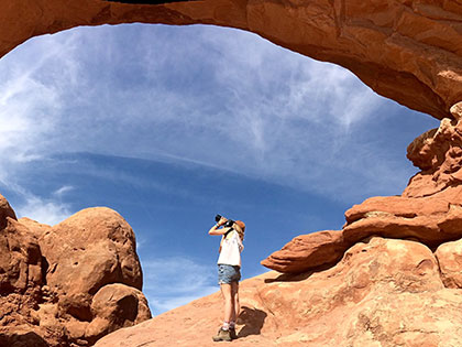 Journalism and digital arts student Kyly Clark photographing rock formations in canyon country