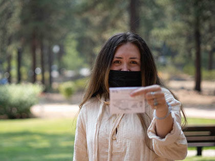 SNU student displays her vaccination card
