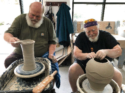 ceramicists Don Ellis and Randy Brodnax throwing pots in tandem