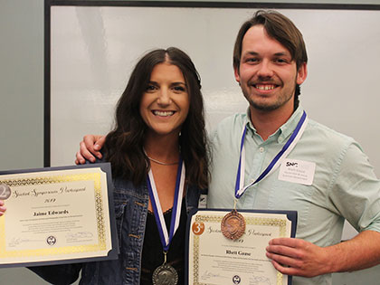 The second and third place winners of the 2019 student symposium at SNC Tahoe stand proudly with their awards.