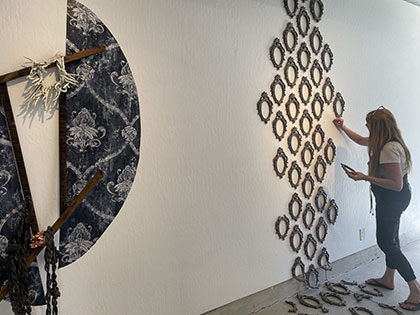 artist Hannah Fridholm installing her BFA exhibition 'Armor's Ashes', which won first place at the Sierra Nevada University 2021 Student Symposium
