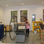 Bachelor of Fine Arts student works with an old school printing press at the Holman Arts & Media Center at SNU Tahoe