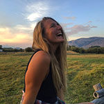 Sustainability and Ski Business Resort Management alumna Marina McCoy enjoys a sunset