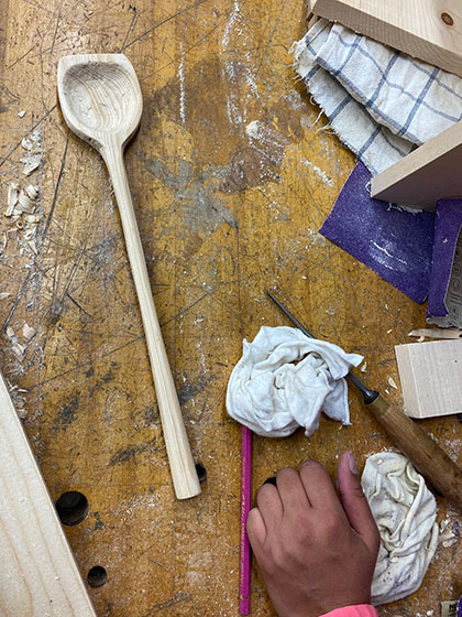 carving a spoon, a shop image from woodworking artist Sasha Petrenko