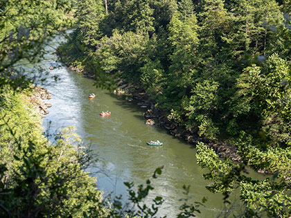 view of rafters from a bluff overlooking the river - Sierra Nevada College environmental science and outdoor adventure leadership students in field courses on the Wild and Scenic Rogue River