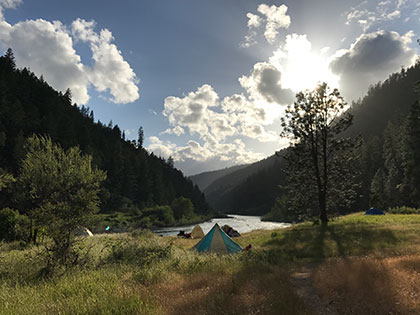 the sun comes up over a peaceful campsite - Sierra Nevada College environmental science and outdoor adventure leadership students in field courses on the Wild and Scenic Rogue River