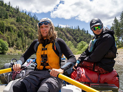 a student rows a heavy gear boat - Sierra Nevada College environmental science and outdoor adventure leadership students in field courses on the Wild and Scenic Rogue River