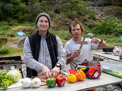 students prepare fresh food for dinner - Sierra Nevada College environmental science and outdoor adventure leadership students in field courses on the Wild and Scenic Rogue River