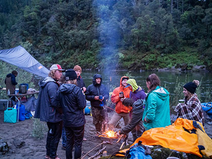 students faculty and river guides are a community around the campfire - Sierra Nevada College environmental science and outdoor adventure leadership students in field courses on the Wild and Scenic Rogue River