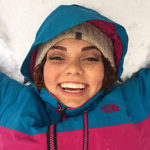 Nicole Ross takes break from reading to lay in the snow at SNC Tahoe