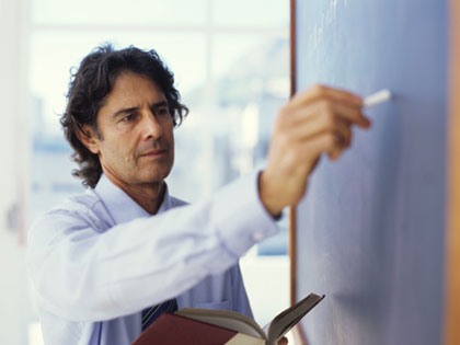 TESL teacher writing on blackboard