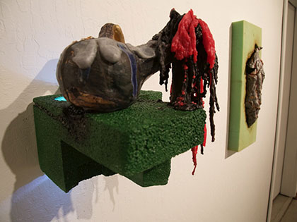 Ian Wieczorek, Bachelor of Fine Arts, displays ceramic piece hanging on wall at SNC Tahoe