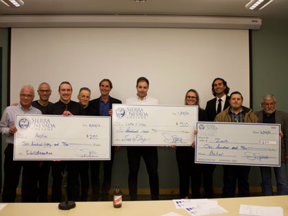 The winners of the 2019 pitch competition pose with their big checks and their expert judges at SNC Tahoe.
