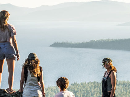 students standing high on a mountain overlooking Lake Tahoe on a sunny summer day