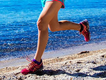 An SNU athlete training on the beach by Lake Tahoe