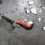 image of a broken and weatherbeaten lightbulb on the concrete floor for SNU fine arts alumna Anna Bunnell's POD exhibition Continual Adjustment
