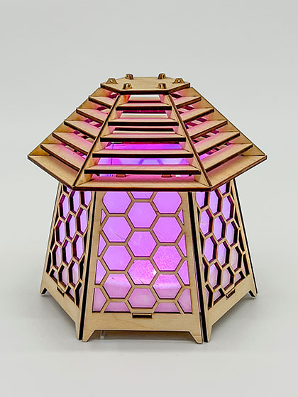 pagoda lamp, illuminated magenta, by laser-cut artist Eric Burns