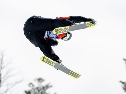 SNC Tahoe student Cole Lyon grabs his skis while in the air during the freeski competition at USCSA