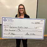 Giulianna Crivello, Entrepreneurship major, holding check she won at the Business Plan Competition