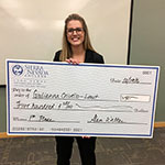 Giulianna Crivello, Entrepreneurship major, holding check she won at the Business Plan Competition