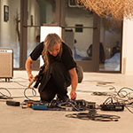 Sound artist Gabie Strong sets up her equipment for a performance during Sierra Nevada College's MFA in Interdisciplinary Arts residency.