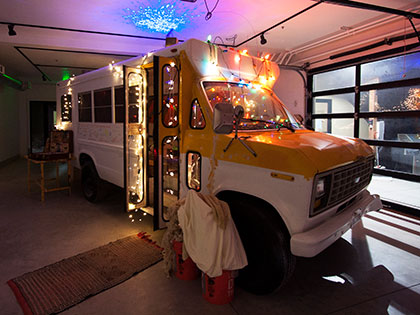 Bachelor of Fine Arts alumna Miranda McFarland strung lights around the bus she calls Juanita's Gallery at SNC Tahoe