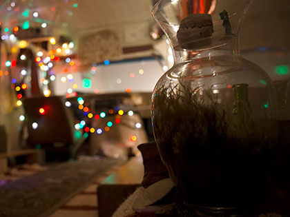 Bachelor of Fine Arts alumna Miranda McFarland strung lights in the bus she calls Juanita's Gallery