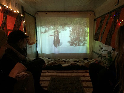 Bachelor of Fine Arts alumna Miranda McFarland projects a movie inside Juanita's Gallery at her exhibition In Sight