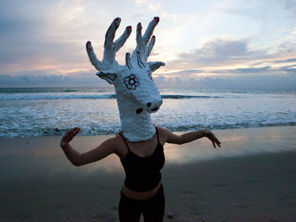 Bachelor of Fine Arts alumna Miranda McFarland plays around with a deer head at the beach