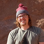 SNU Tahoe student Nathan Moose headshot while climbing in Moab