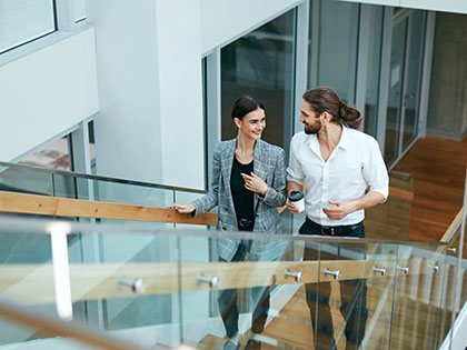 young businesspeople walking up stairs in a new office building