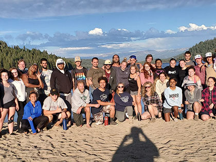 Sierra Nevada University students gather on the beach at the end of a whitewater rafting trip