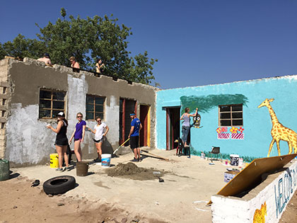 Sierra Nevada College International Studies students paint fun murals on the walls of a preschool in rural South Africa