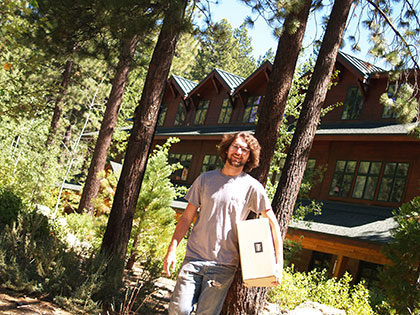 Sierra Nevada University student carrying a package from the mailroom to their dorm
