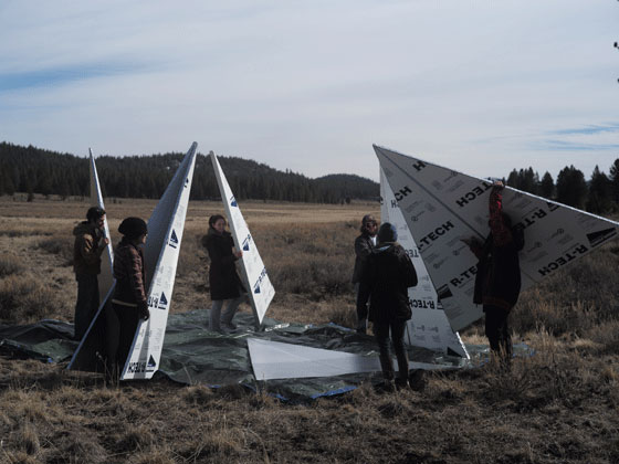 foam panels being assembled into an outdoor installation in the high desert by students in the Sierra Nevada University fine arts program