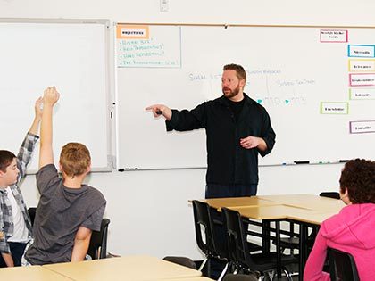Male teacher working in elementary school classroom