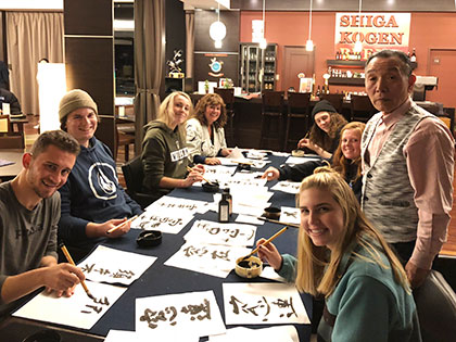 SNC students in a Fine Arts travel course to Japan learning Japanese brush calligraphy