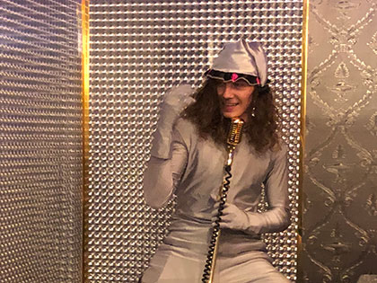 SNC fine arts student Sam Shinkle performing costumed karaoke during a travel course to Japan
