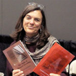 Author Ingrid Wendt holding copies of her work
